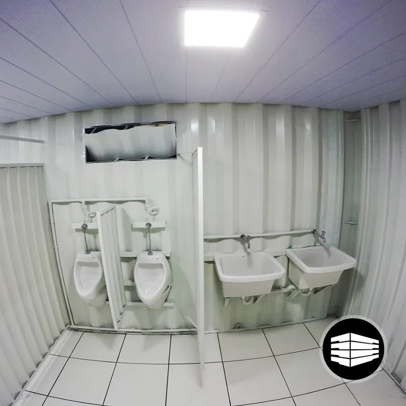 Interior de container sanitário com mictórios e pias
